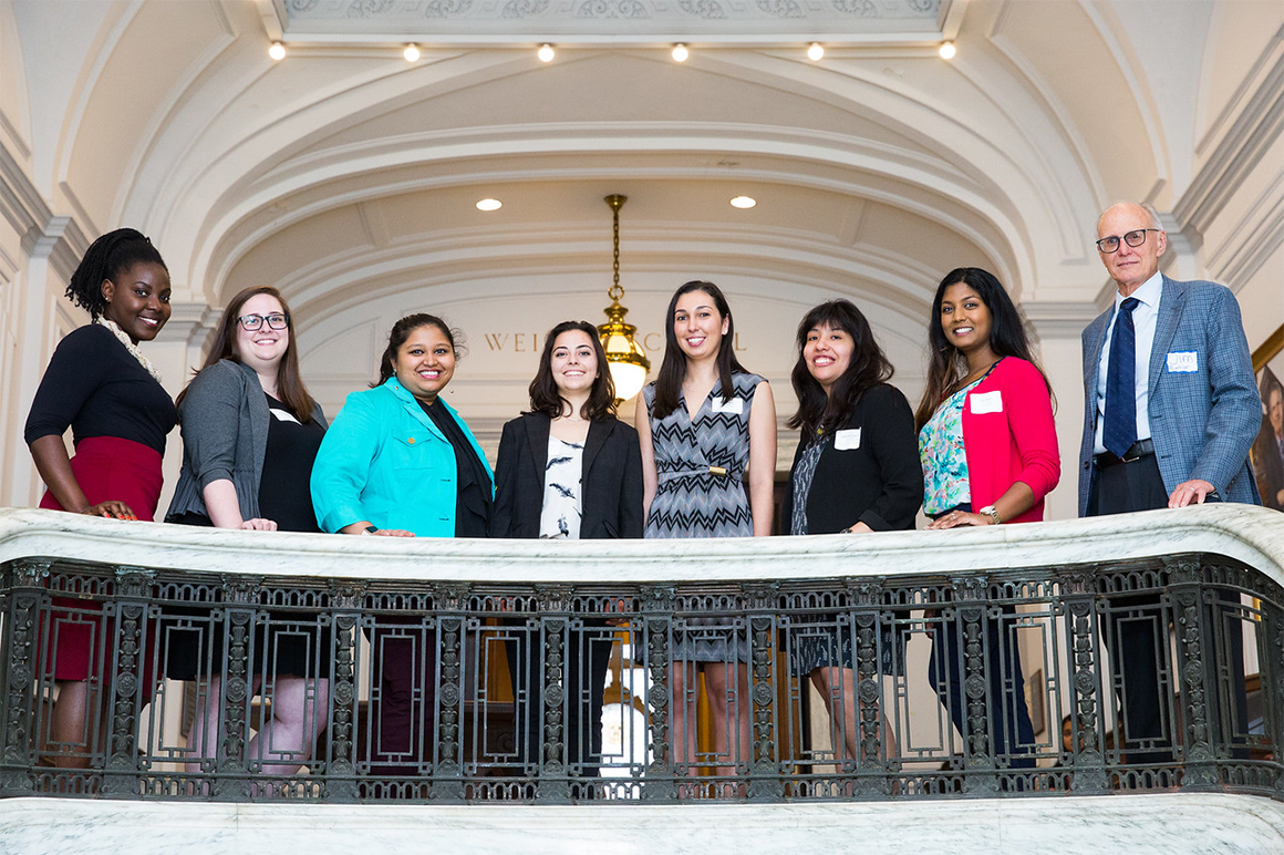 Students smiling along stairwell